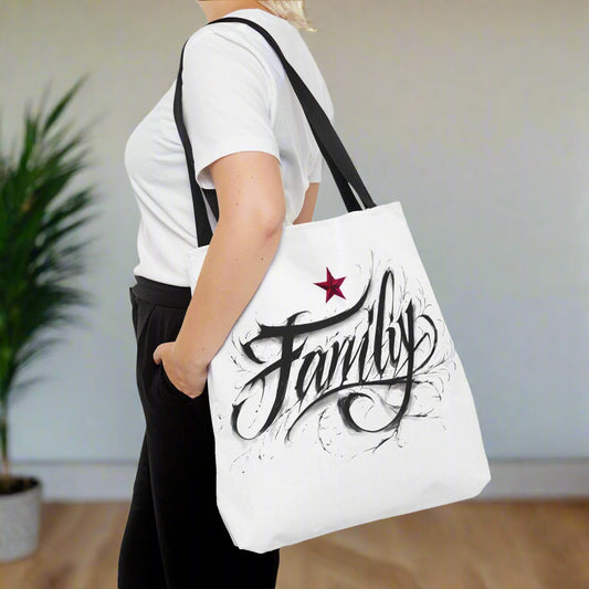 Person holding a white tote bag with 'Family' and a star design.