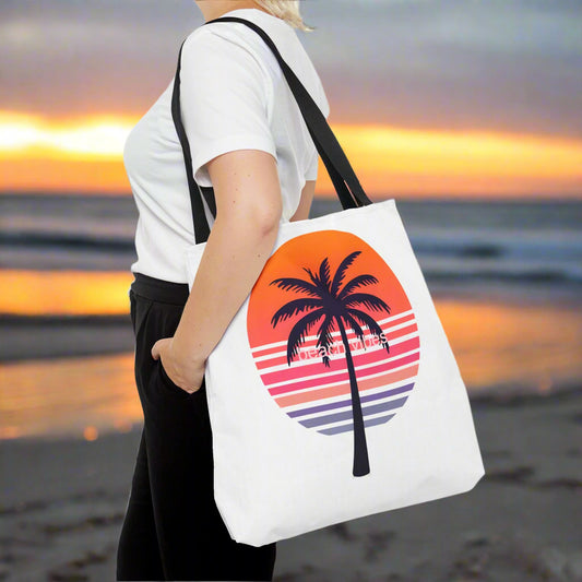 White tote bag with a palm tree and sunset design.