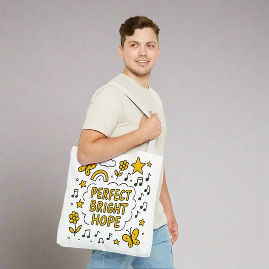Man holding a tote bag with decorative symbols and Perfect Bright Hope text on a white background